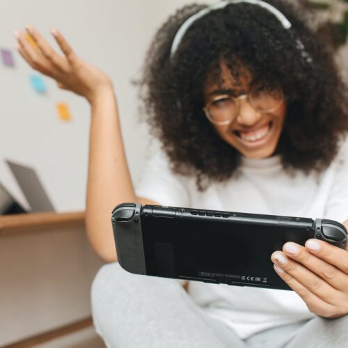 a woman playing with a video game console