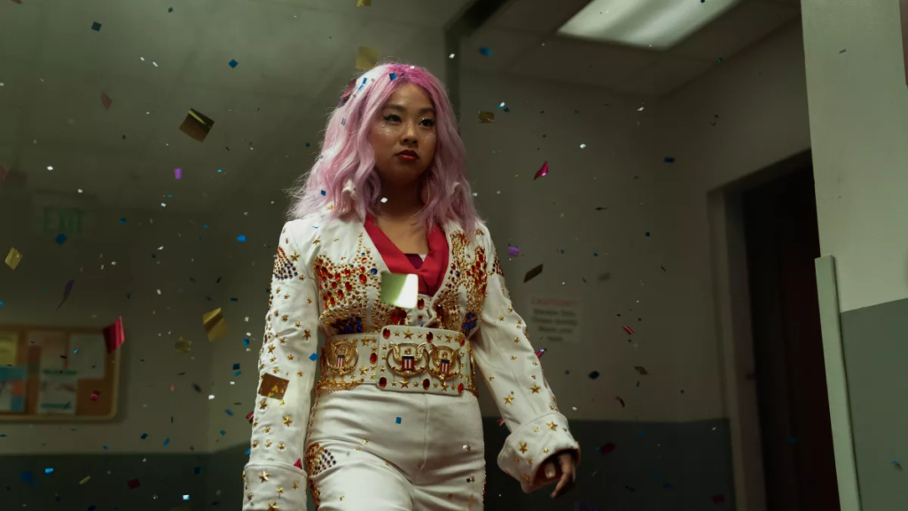 Stephanie Hsu with pink hair and glitter falling around her in “Everything Everywhere All at Once.” (Allyson Riggs)