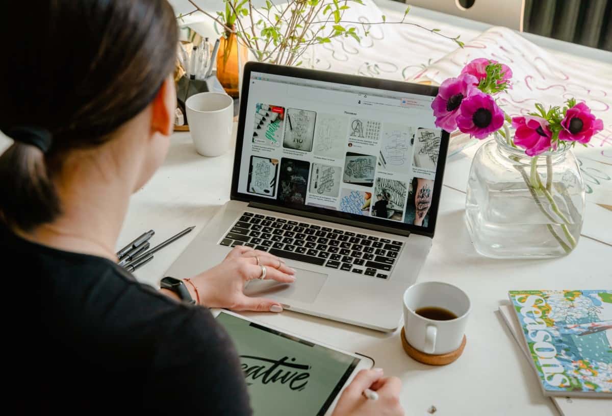 photo of person using laptop for graphic design | bluehost self hosted wordpress website